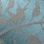 Close-up of the leaf design in teal and taupe, showing the branching silhouette woven into the satin