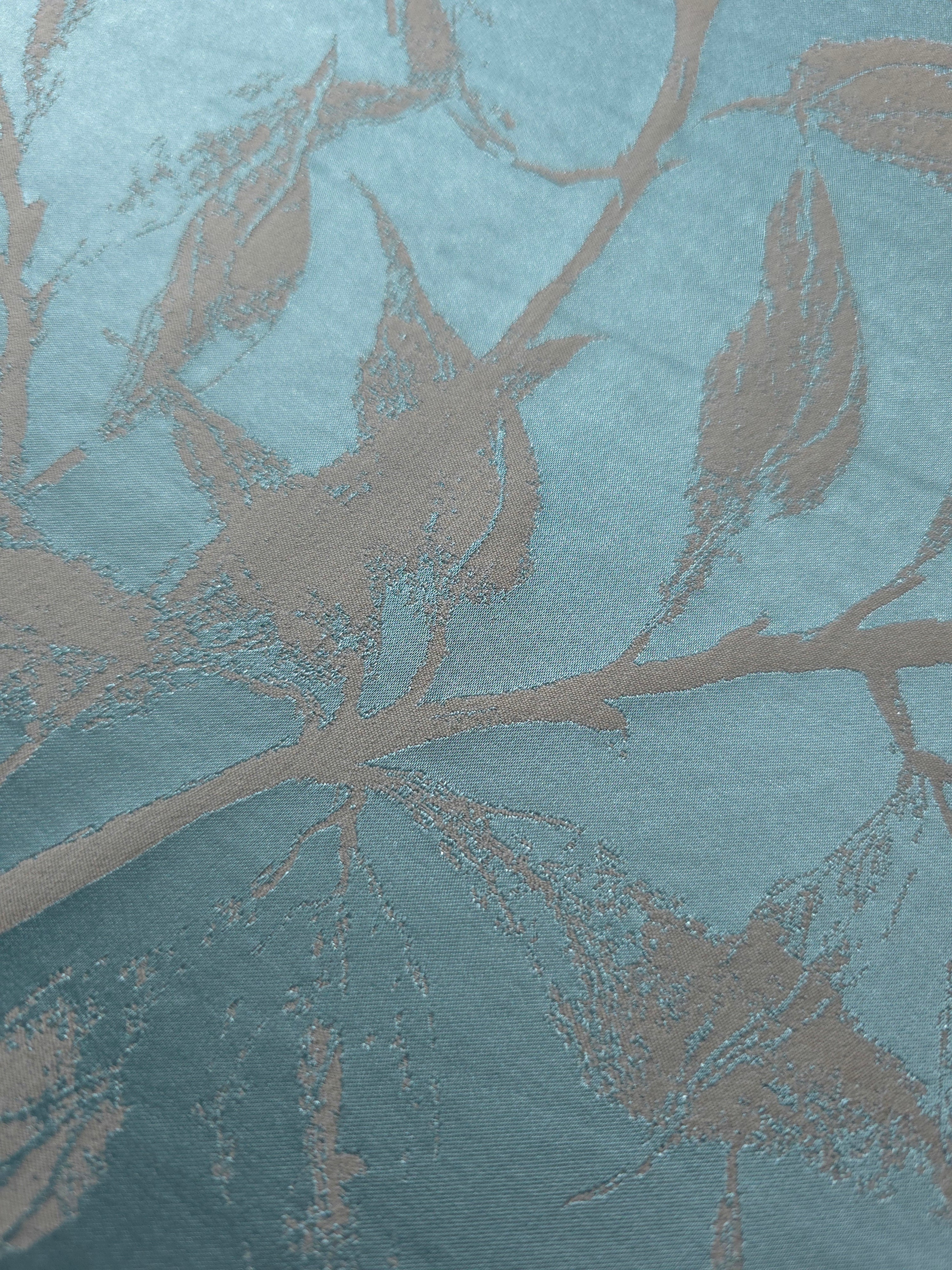 Close-up of the leaf design in teal and taupe, showing the branching silhouette woven into the satin
