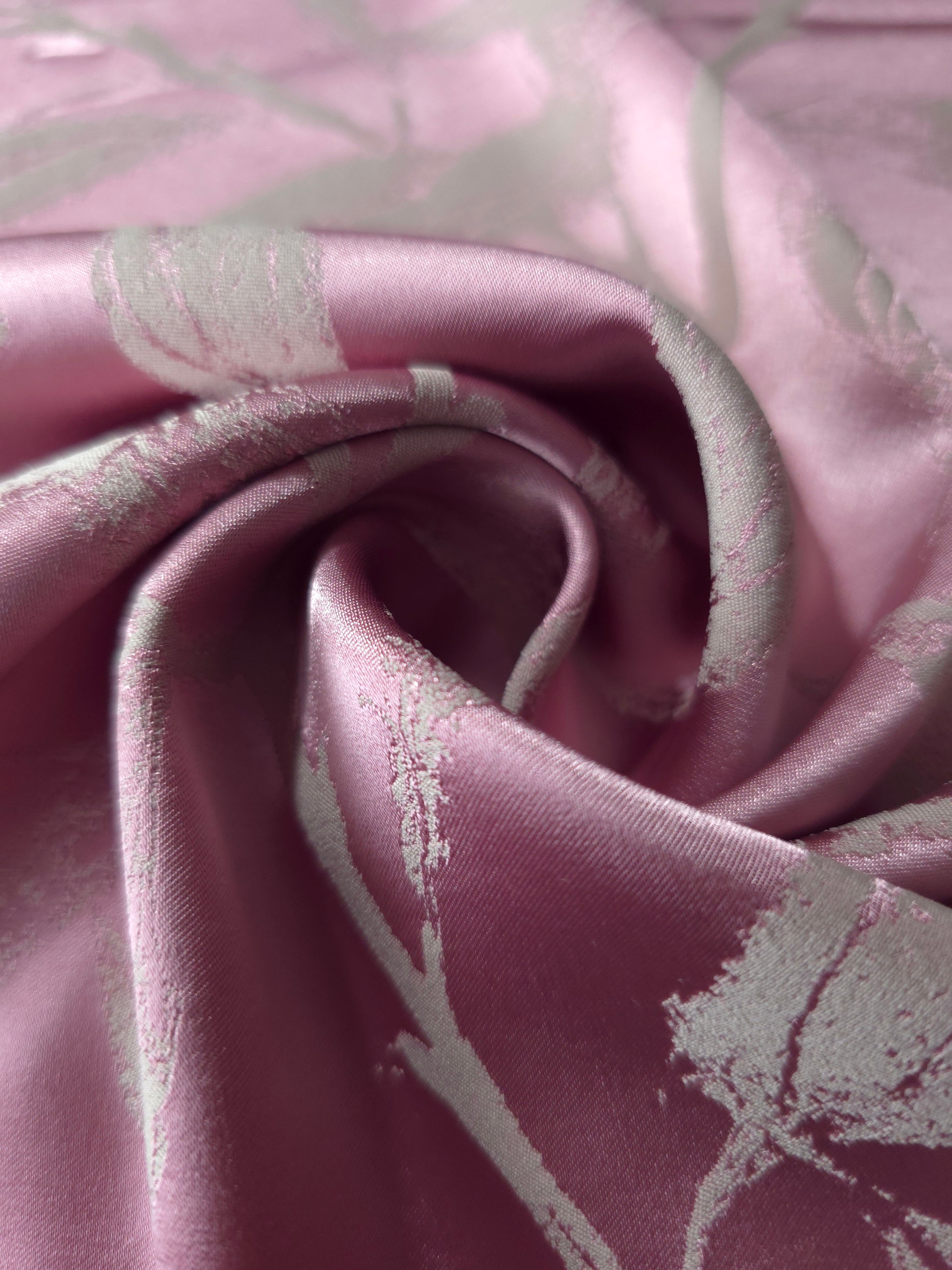 A tight fold in the mauve-plum satin, the leaf branches bending with the crease of the fabric