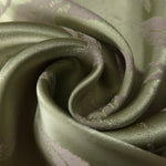 A soft crease in the olive satin, the leaf motif visible mainly through the shift in sheen