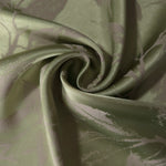Olive green Lassi satin draped loosely, suited to buyers wanting an earthy, low-contrast leaf print