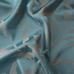 Teal Lassi satin folded over, the taupe leaf-and-branch motif curving across the crease
