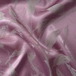 Mauve-plum satin folded over, the grey leaf branches standing out softly against the warm purple base