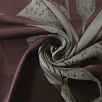 Maroon lily flower satin draped to show its glossy movement against the sage petal detail