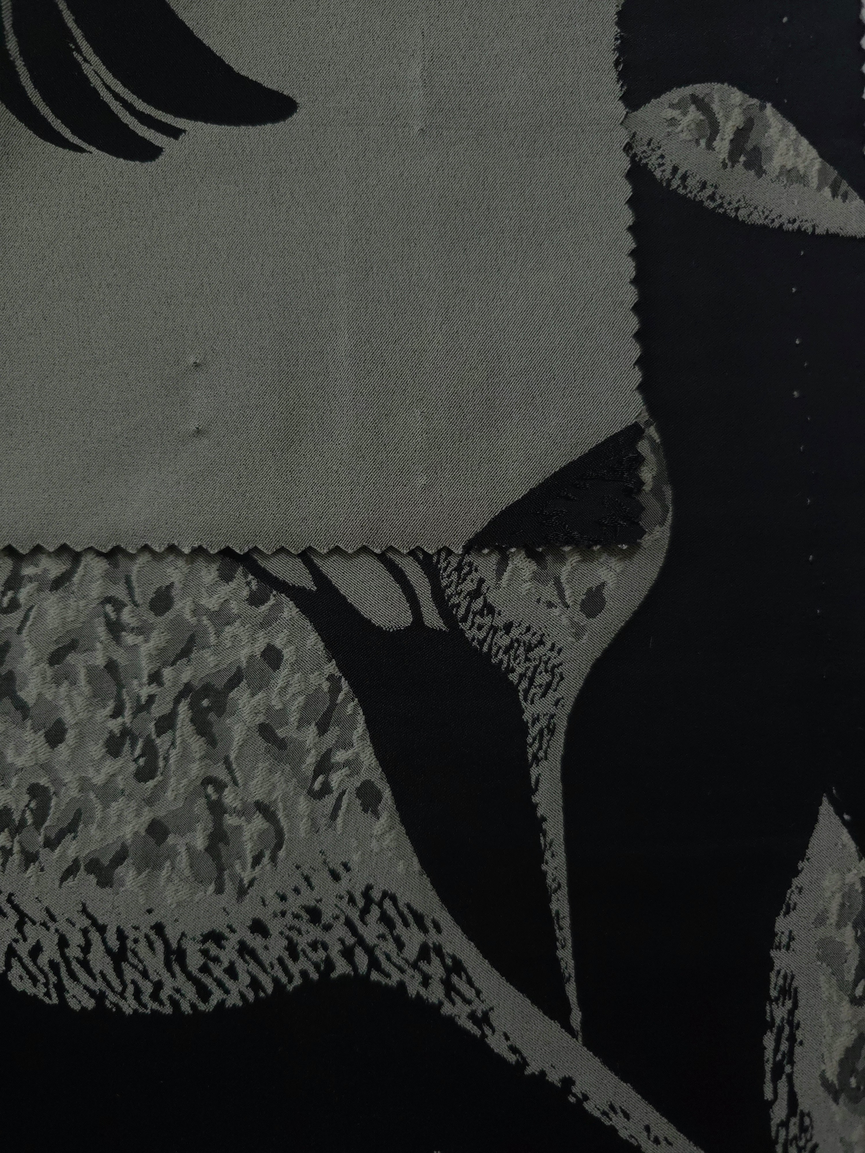 Black colorway shown front and back, the reverse side reading as a deep charcoal rather than true black