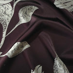Deep plum satin folded over, the sage lily petals showing the same speckled texture as the maroon colorway in a darker base