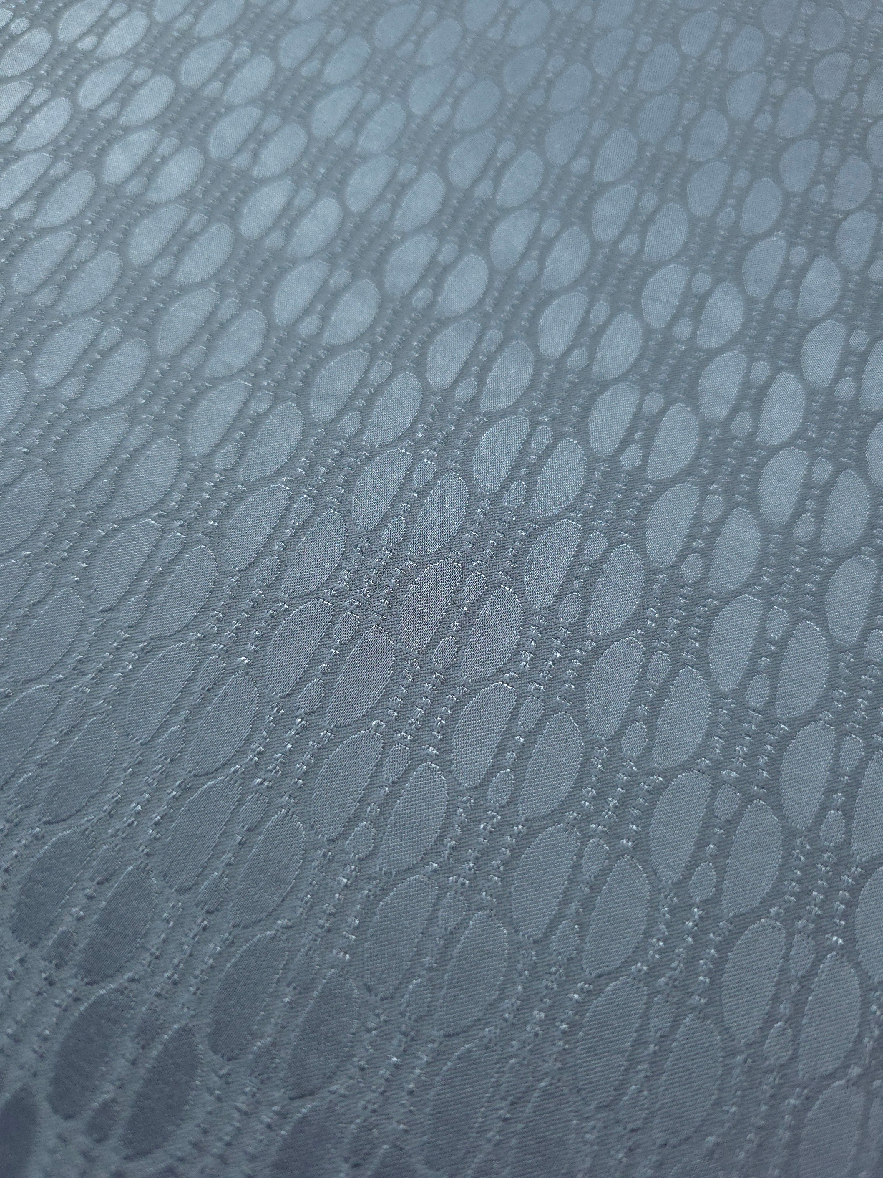 Close-up of the slate blue oval lattice colorway, a geometric repeat rather than a floral or organic motif