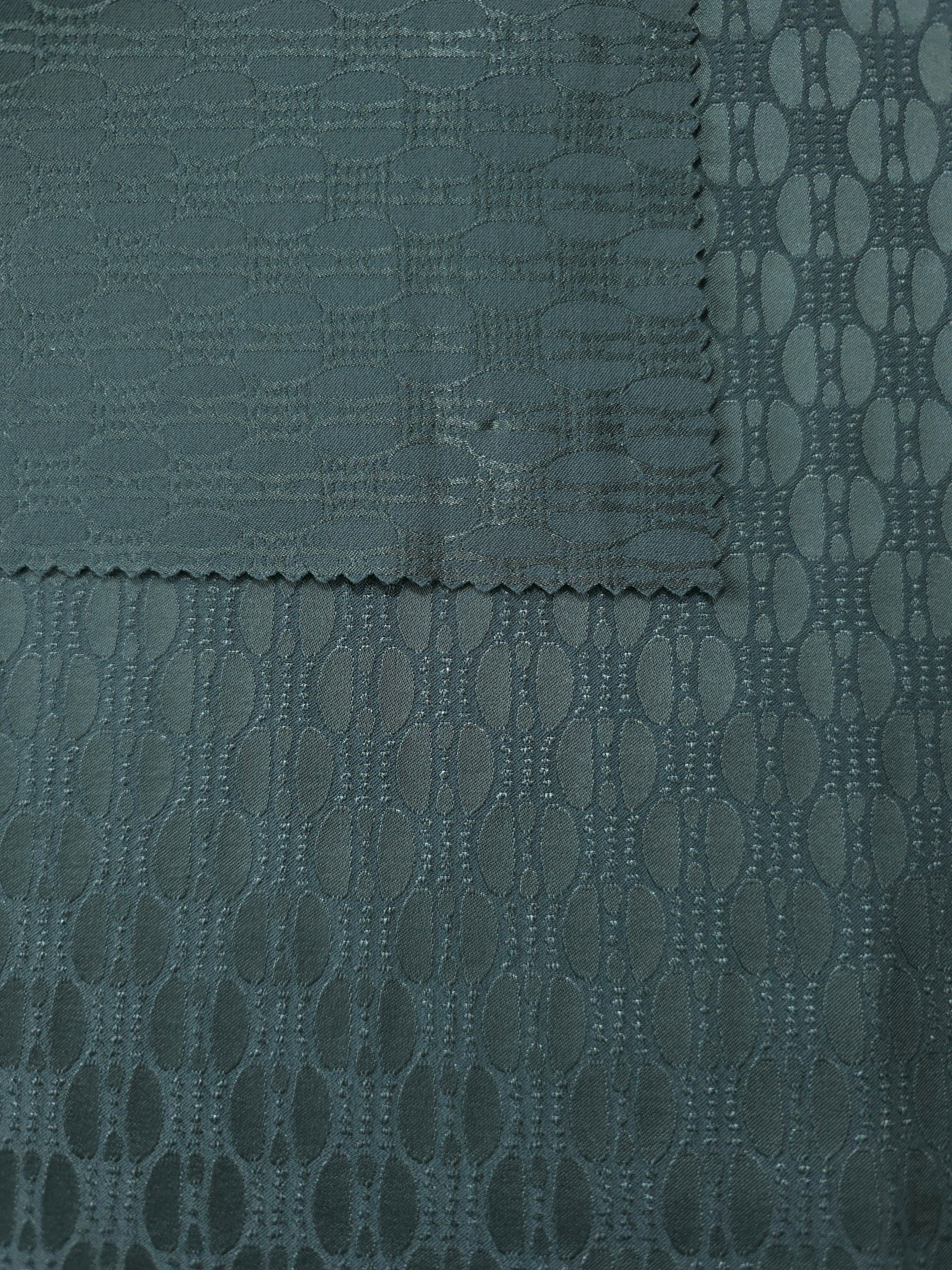 Front and back of the teal-green colorway, the glossy face slightly more saturated than its reverse