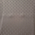 A wider view of the taupe-bronze oval lattice satin laid flat, showing the full repeat