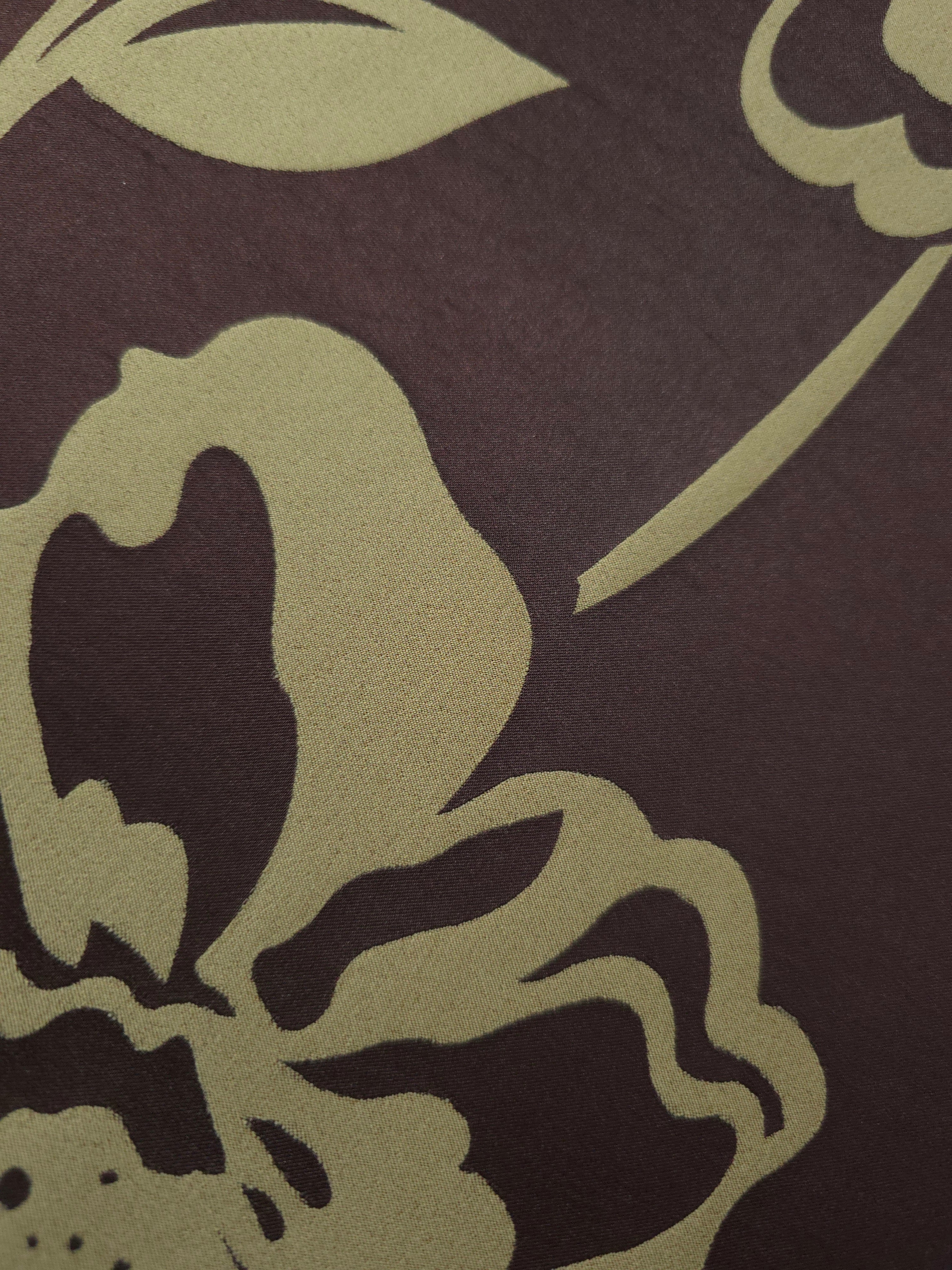 Close-up of the aubergine and sage pansy flower colorway, a high-contrast floral rather than the tonal motifs in this line