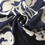 Navy pansy flower satin draped to show its glossy movement against the silver-grey petal outline