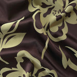 Aubergine satin folded over, the sage-green pansy flower silhouette standing out boldly against the deep purple-brown base
