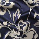 Navy satin folded over, the silver-grey pansy flower outline standing out crisply against the deep blue base