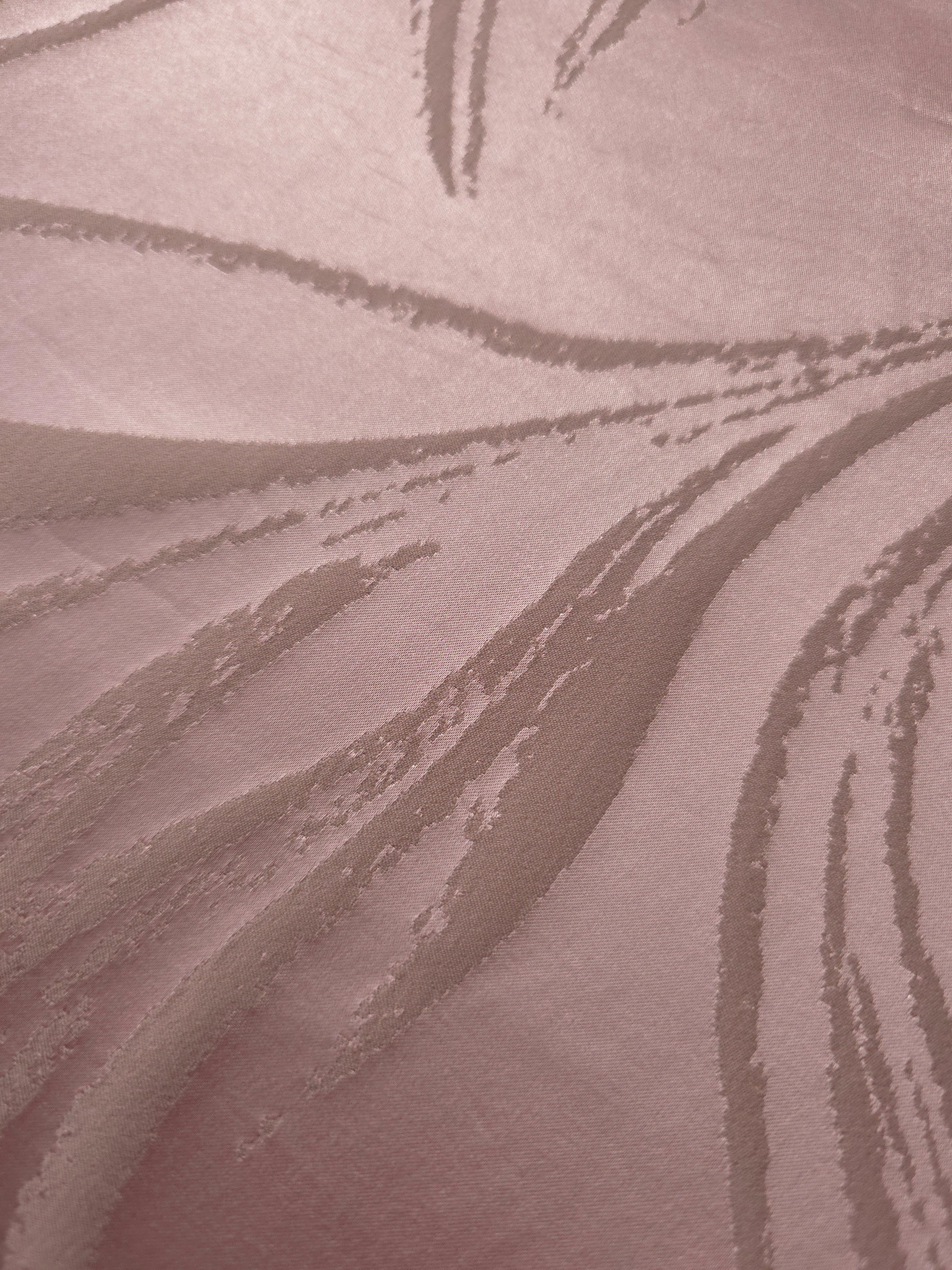 Close-up of the seaweed pattern woven into dusty rose stretch satin, visible mainly through sheen rather than color contrast