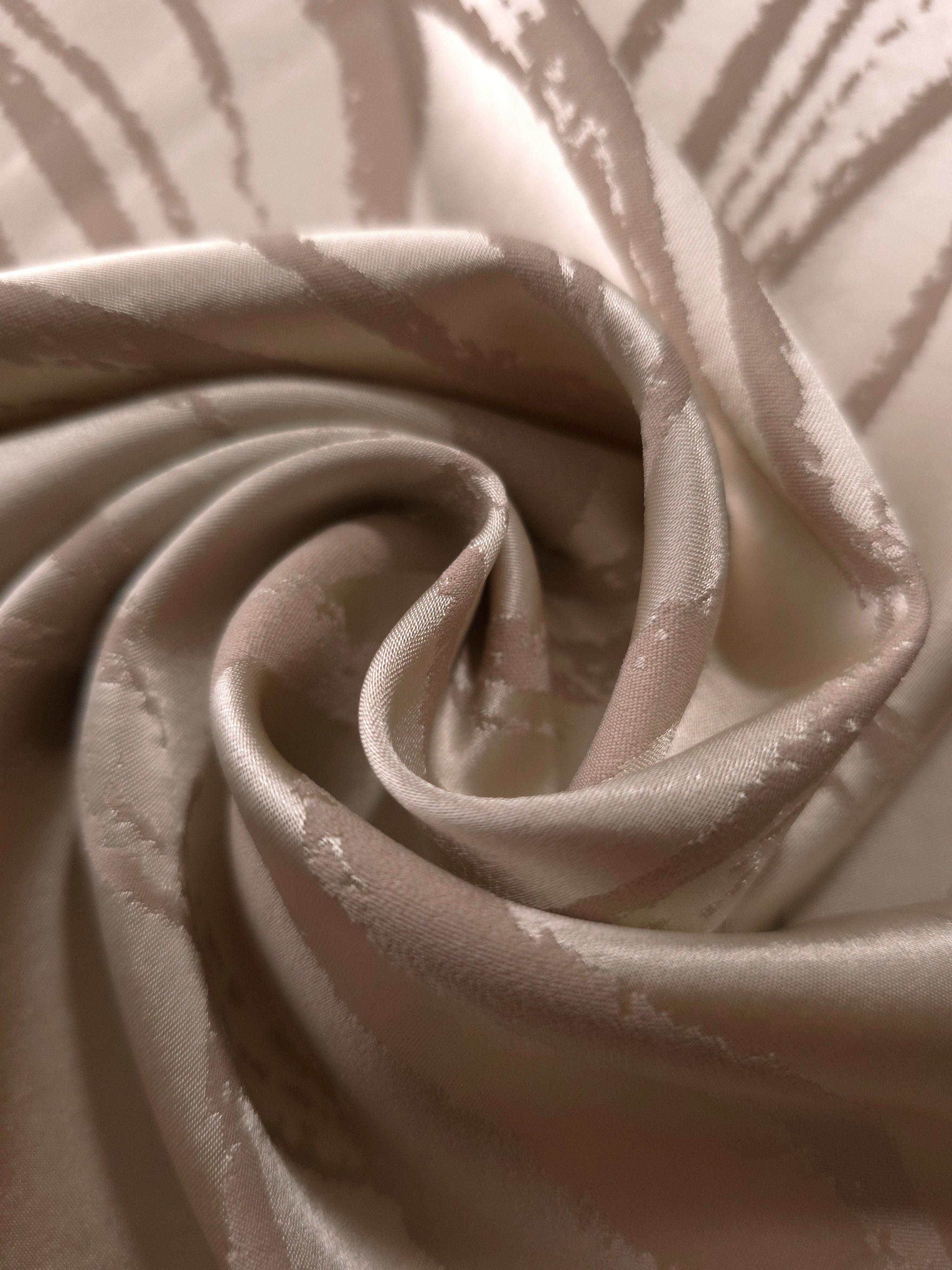 A gentle fold in the champagne satin, showing how understated the seaweed motif reads in this pale tone