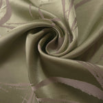 Sage green Lassi satin draped to show its fluid movement, the seaweed lines visible across the curve of the fold