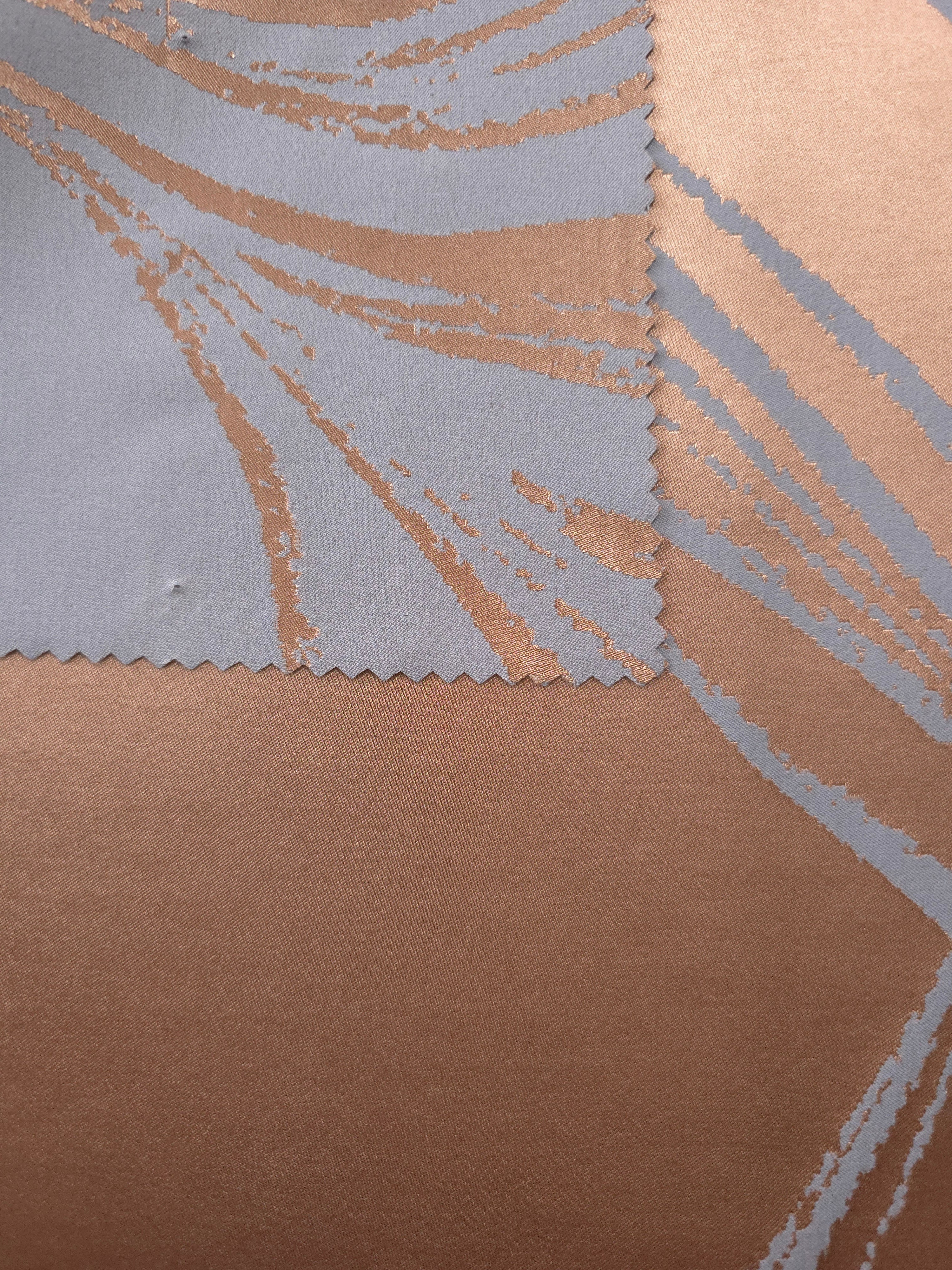 Front and back of the copper colorway, showing the shift from glossy copper to a softer, matte blue-grey reverse