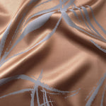 Copper-toned satin folded against itself, with the blue-grey seaweed lines crossing through the warm base color