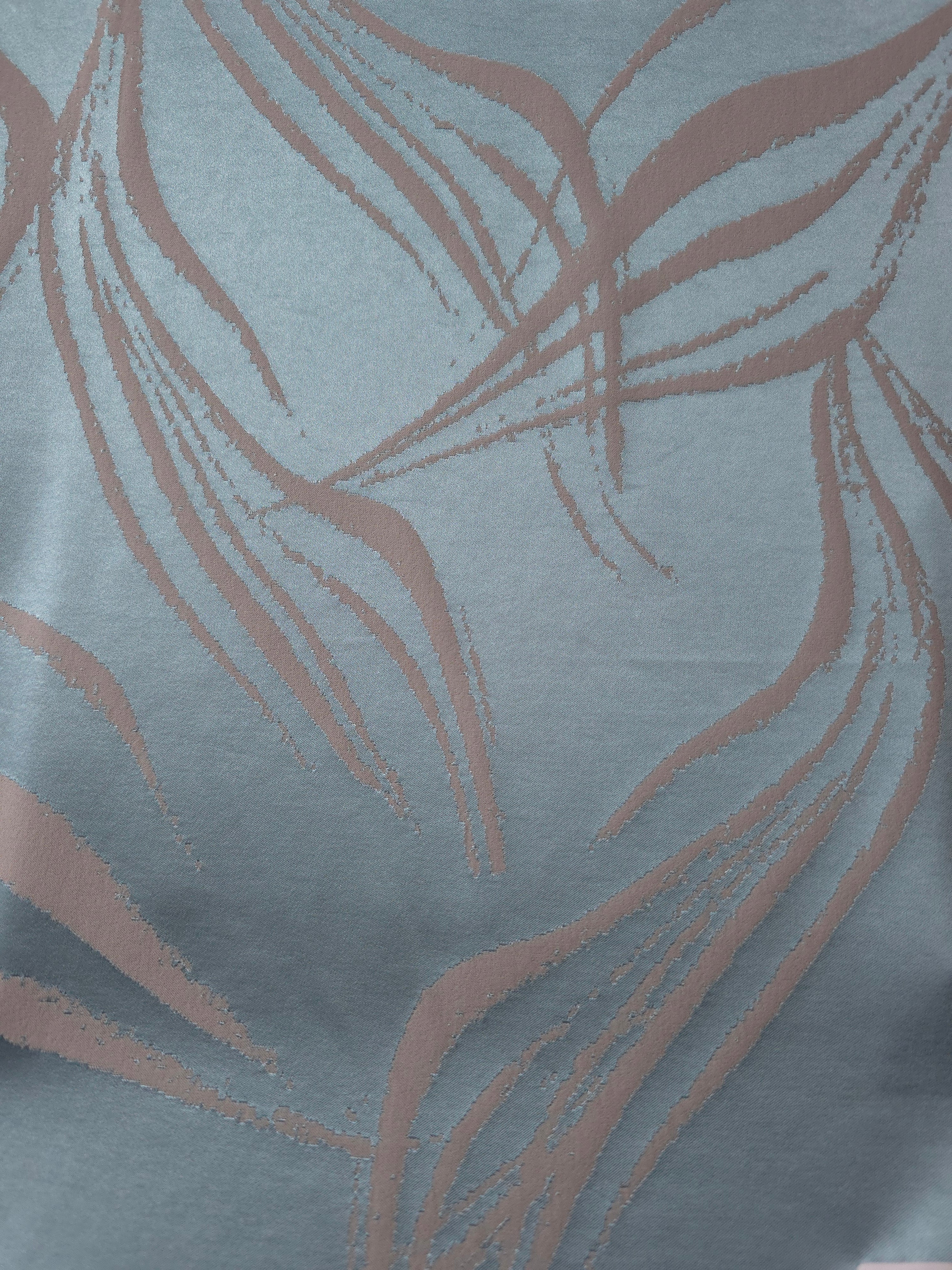 Full width of the slate blue and mauve seaweed satin, shown unfolded to see the repeat of the motif