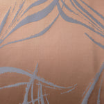 A wider view of the copper and blue-grey seaweed satin laid out, showing the full scale of the repeat