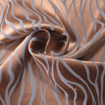 Copper wave-pattern satin draped to show its glossy movement and the contrast of the blue-grey lines