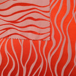 Front and back of the orange-red colorway, the glossy face far more saturated than its muted reverse
