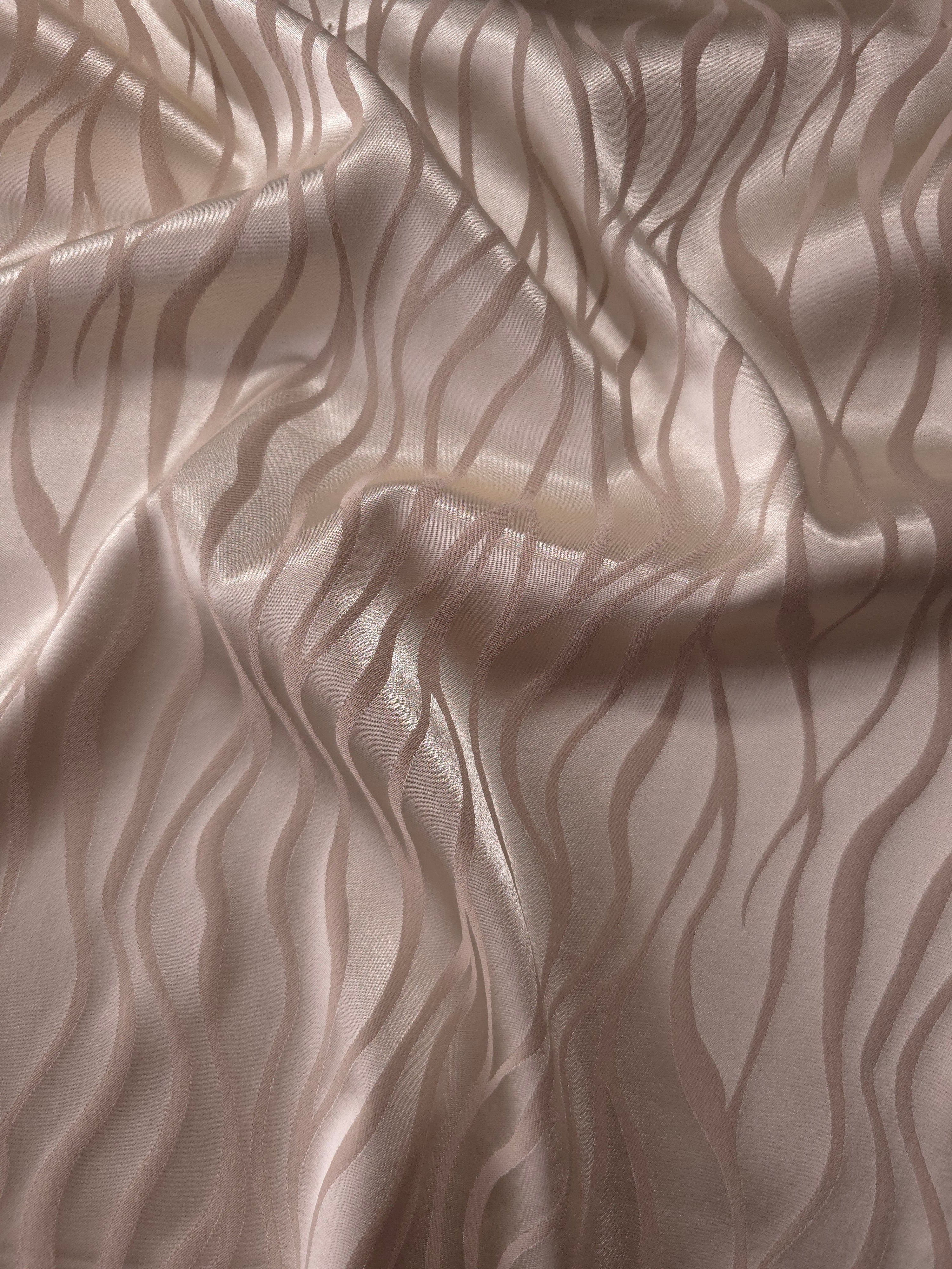 Taupe-grey satin folded softly, the wave motif reading almost entirely through sheen since the colorway is tonal