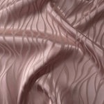 Mauve-plum satin folded gently, the wave lines emerging through tonal sheen rather than strong contrast