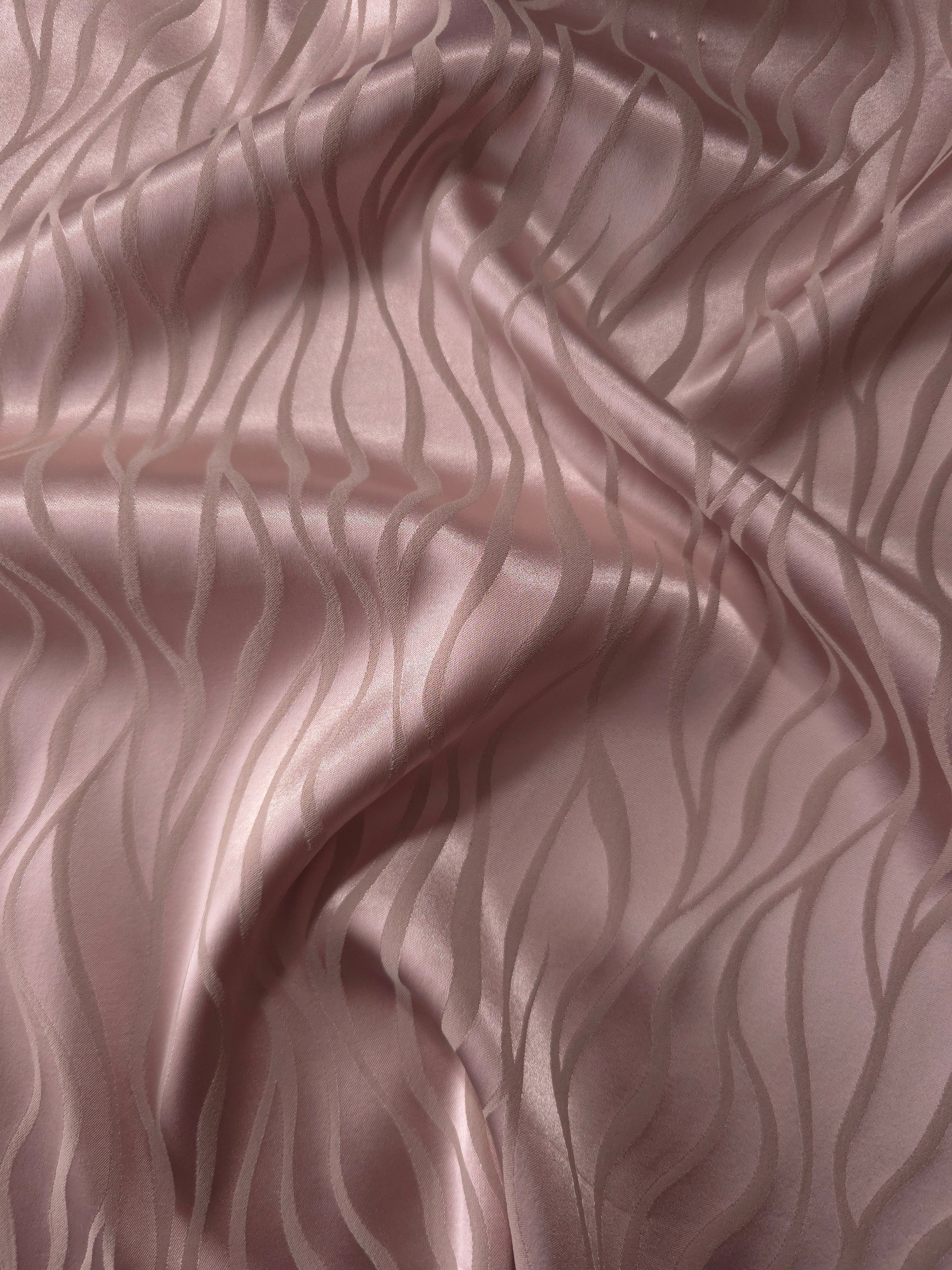 Mauve-plum satin folded gently, the wave lines emerging through tonal sheen rather than strong contrast