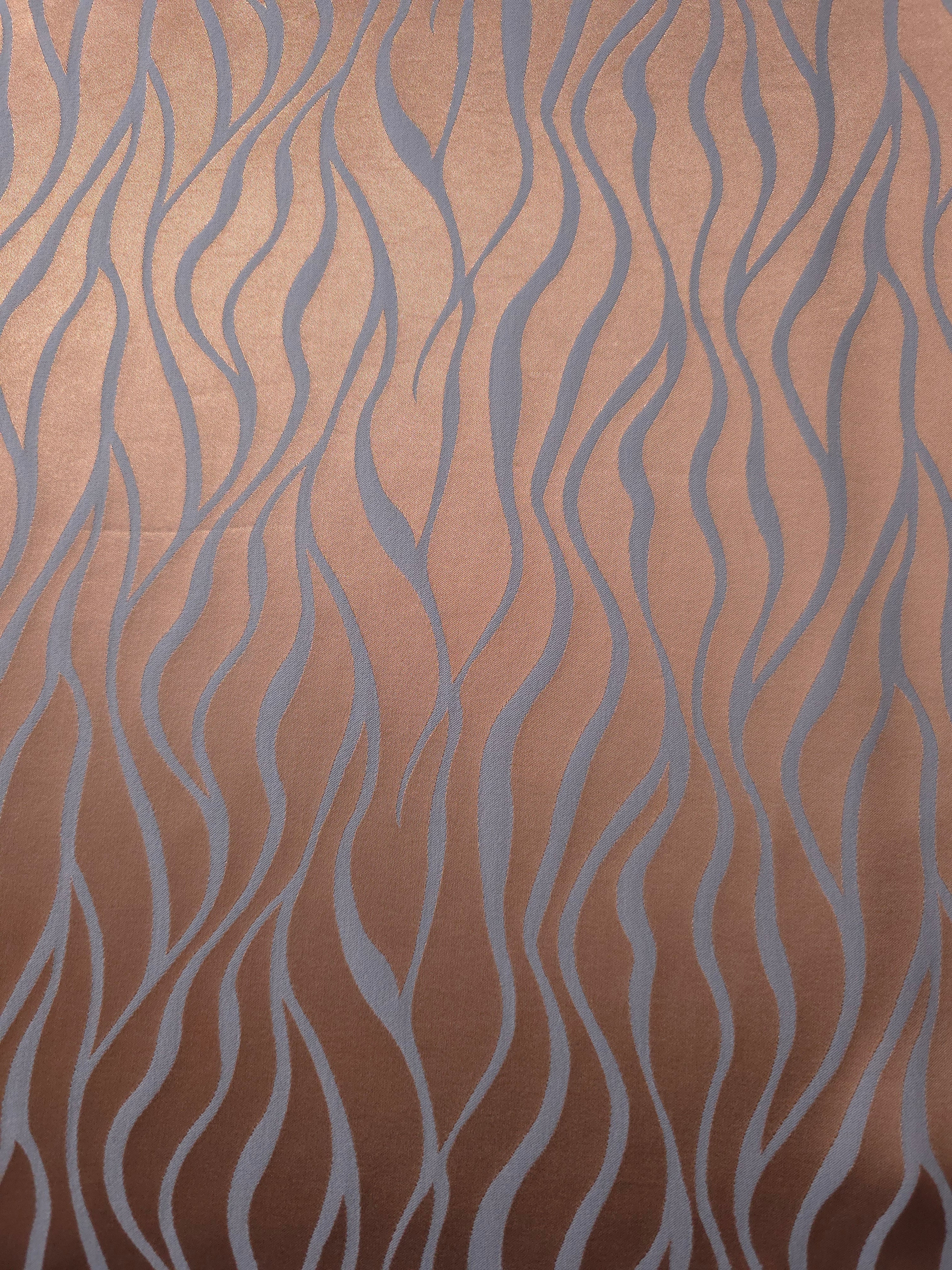 A wider cut of the copper and blue-grey wave satin, shown unfolded to judge the scale of the repeat