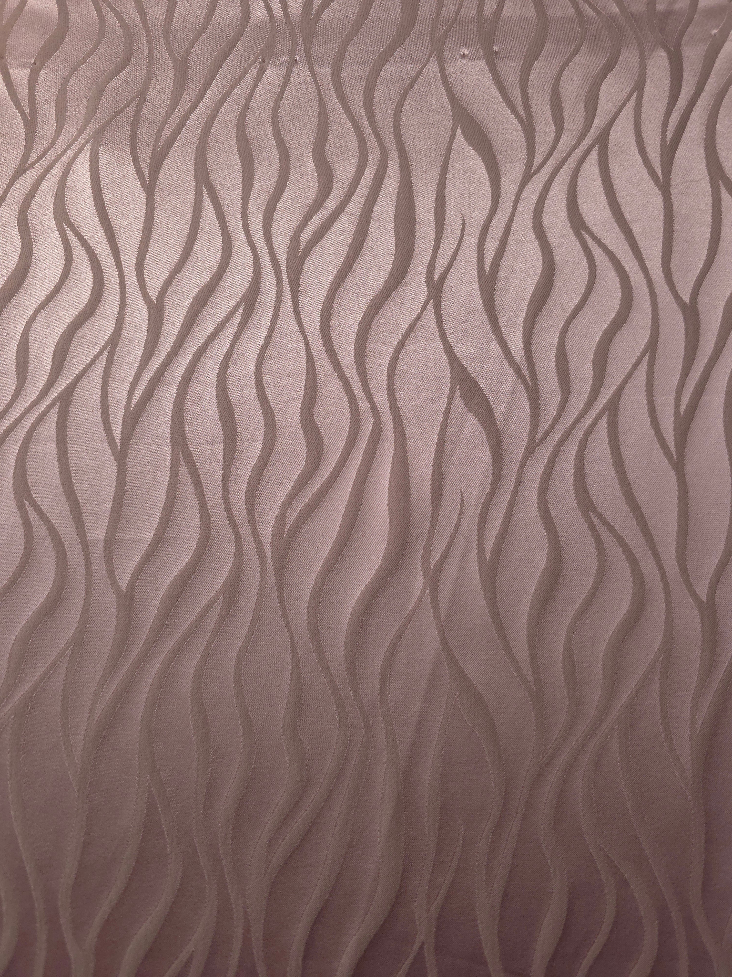 A wider cut of the mauve-plum wave satin laid out, showing the full repeat of the tonal pattern