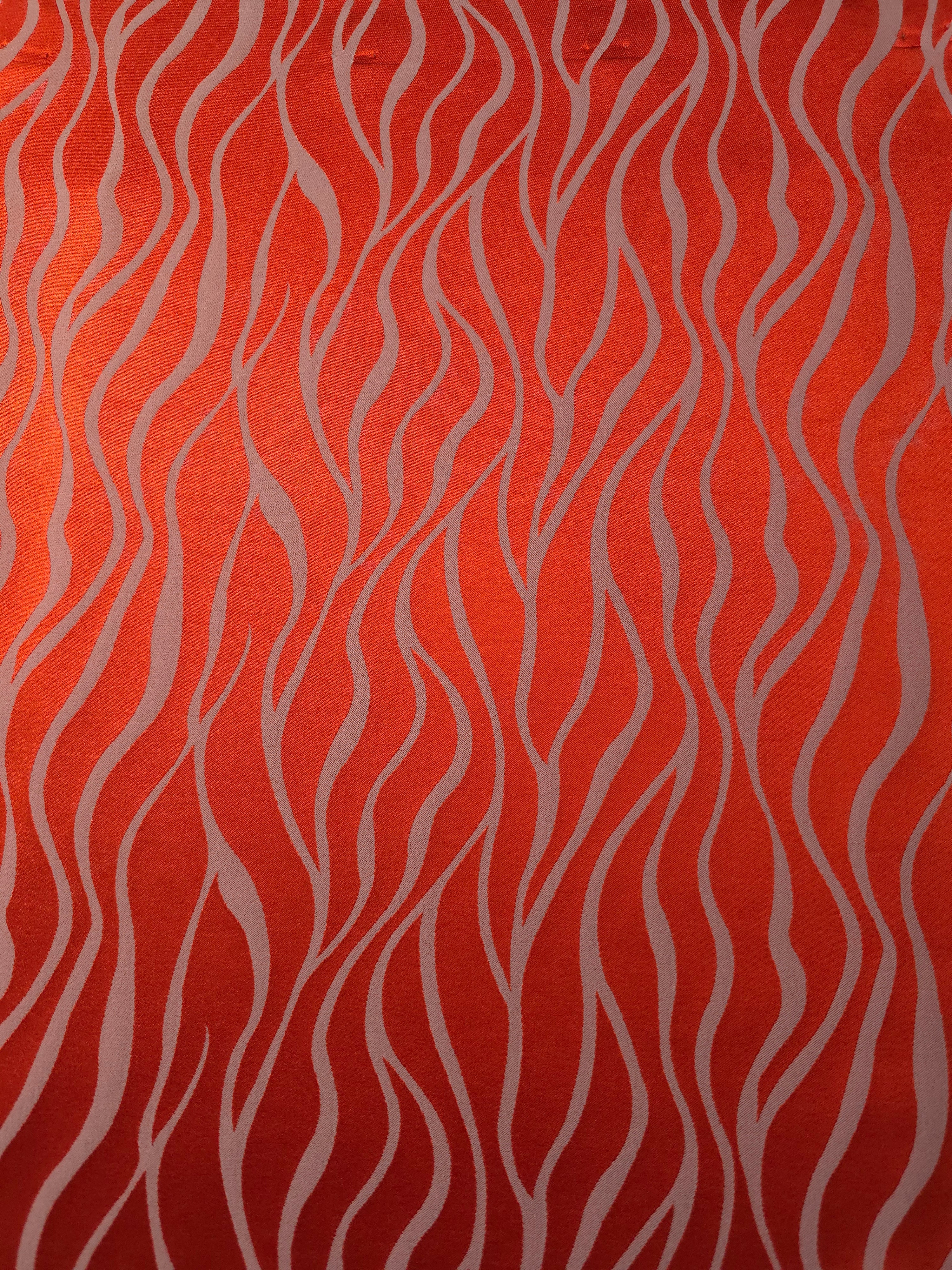 A wider section of the orange-red and ivory wave satin, shown to give a sense of the full pattern at scale