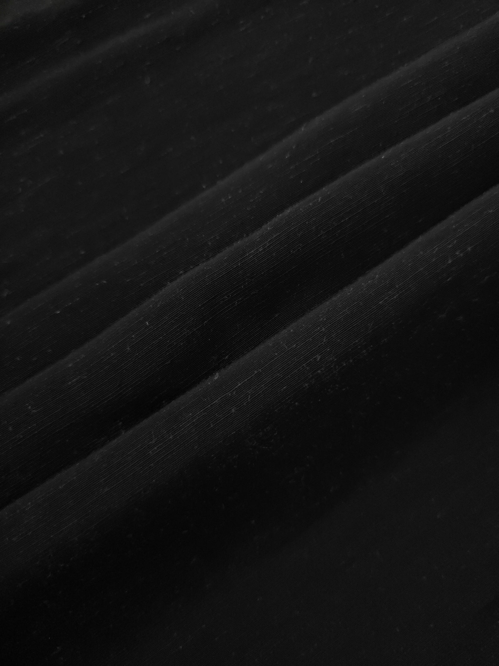 Texture view of deep black linen viscose plain fabric highlighting its flowy, breathable finish.