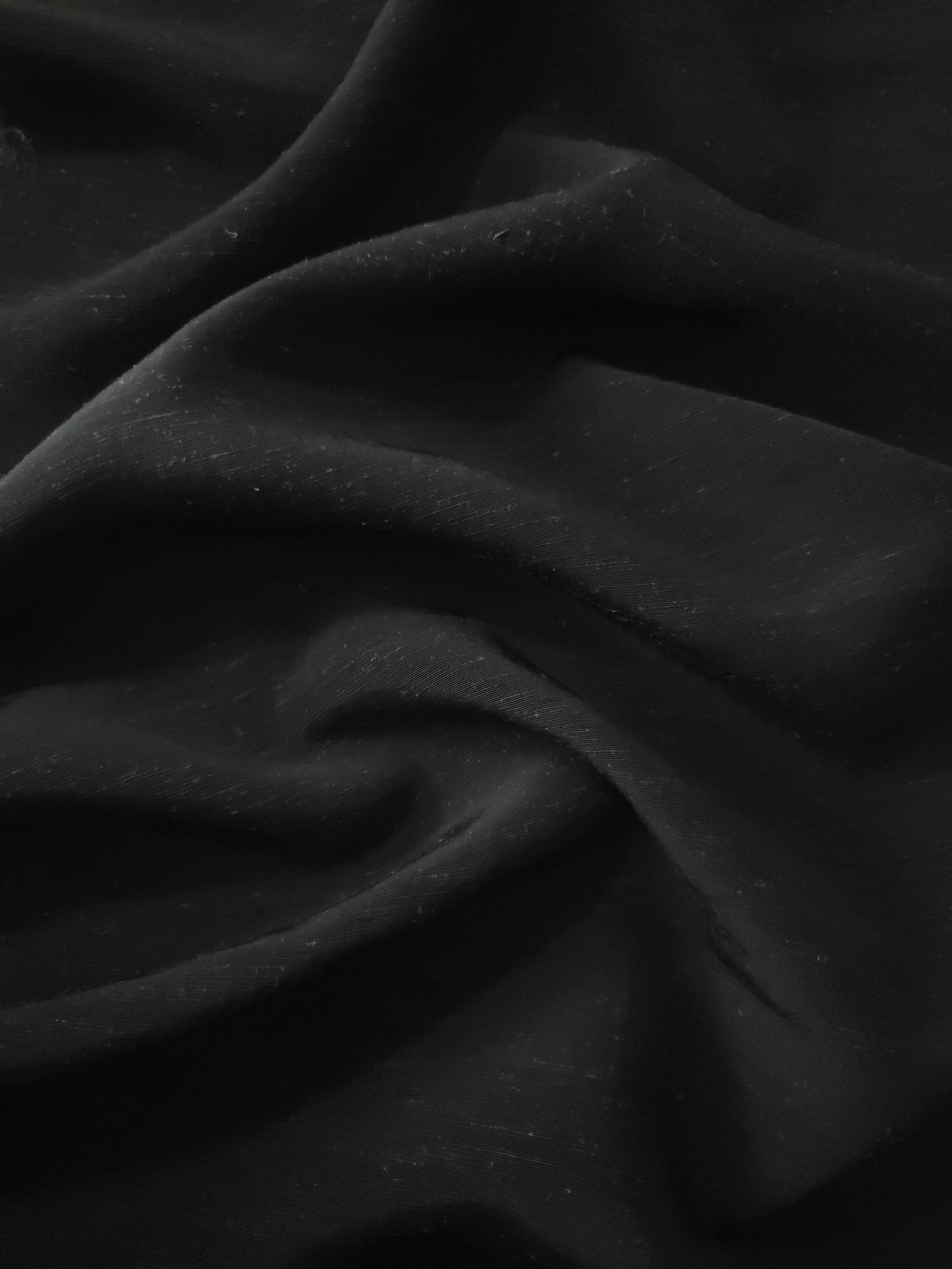 Deep black linen viscose plain fabric styled for modestwear, with a matte, soft-touch finish.
