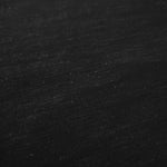Deep black linen viscose plain fabric draped to show its soft structure, ideal for dressmaking.