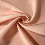 Delicate blush pink linen viscose plain fabric texture, showing the soft, flowy hand of the weave.