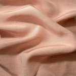 Delicate blush pink linen viscose plain fabric shown styled for abaya and modestwear designs.