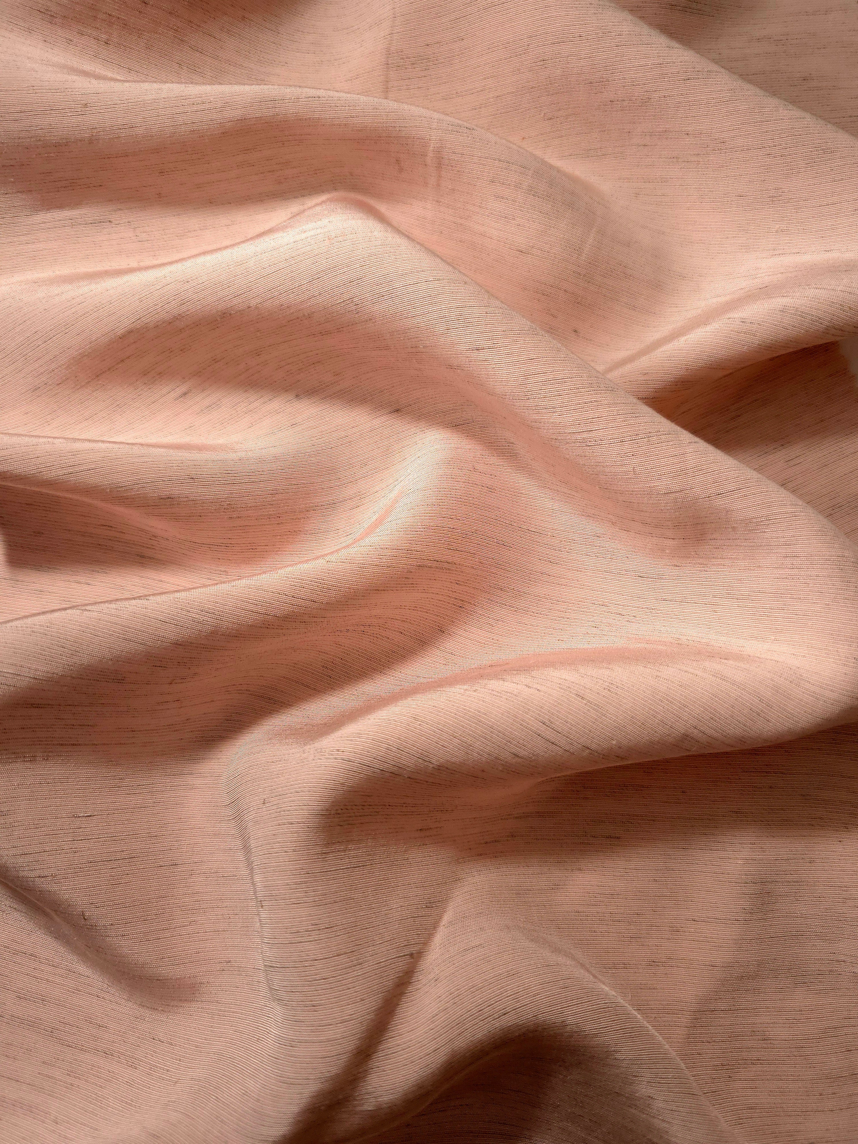 Delicate blush pink linen viscose plain fabric shown styled for abaya and modestwear designs.