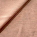 Macro detail of delicate blush pink linen viscose plain fabric, highlighting the plain weave's natural grain.