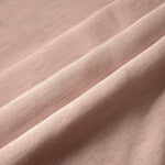 Soft dusty rose linen viscose plain fabric texture, showing the soft, flowy hand of the weave.