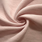 Folded soft dusty rose linen viscose plain fabric, illustrating its lightweight feel for garment sewing.
