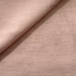 Macro detail of soft dusty rose linen viscose plain fabric, highlighting the plain weave's natural grain.