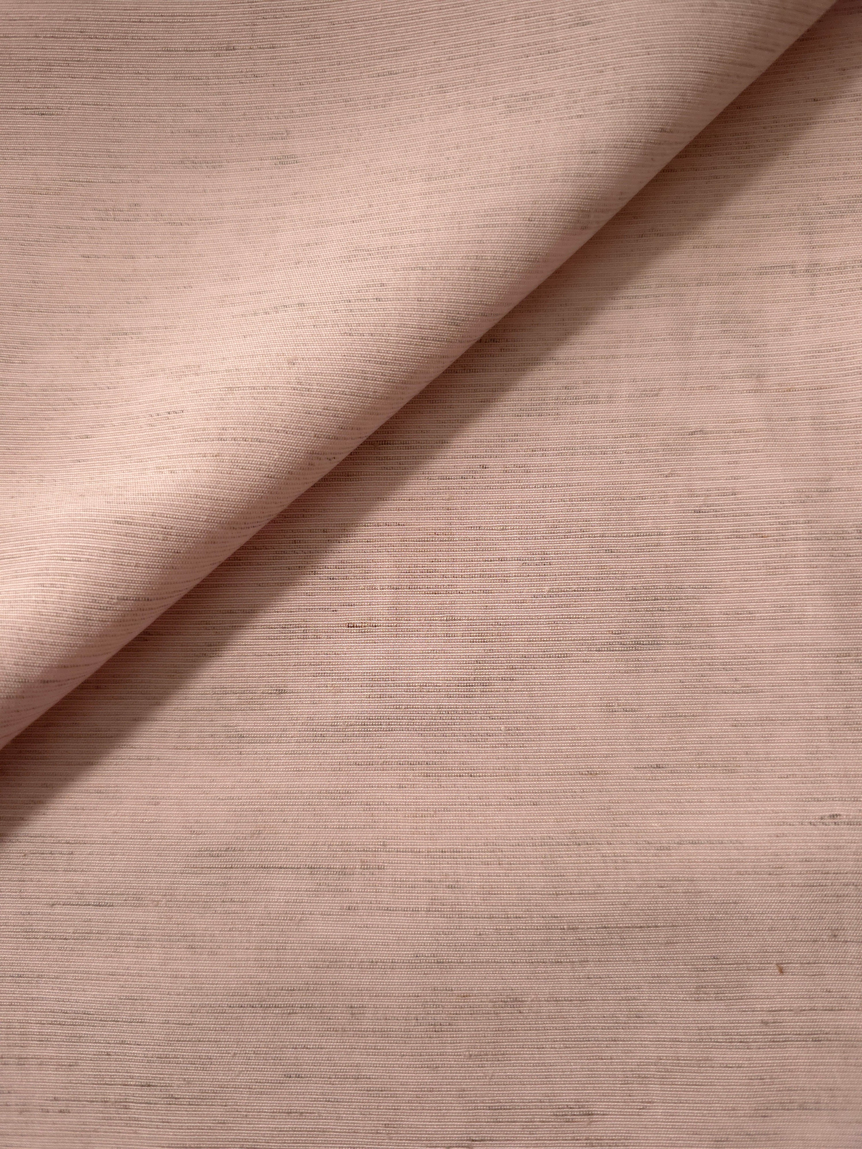 Macro detail of soft dusty rose linen viscose plain fabric, highlighting the plain weave's natural grain.