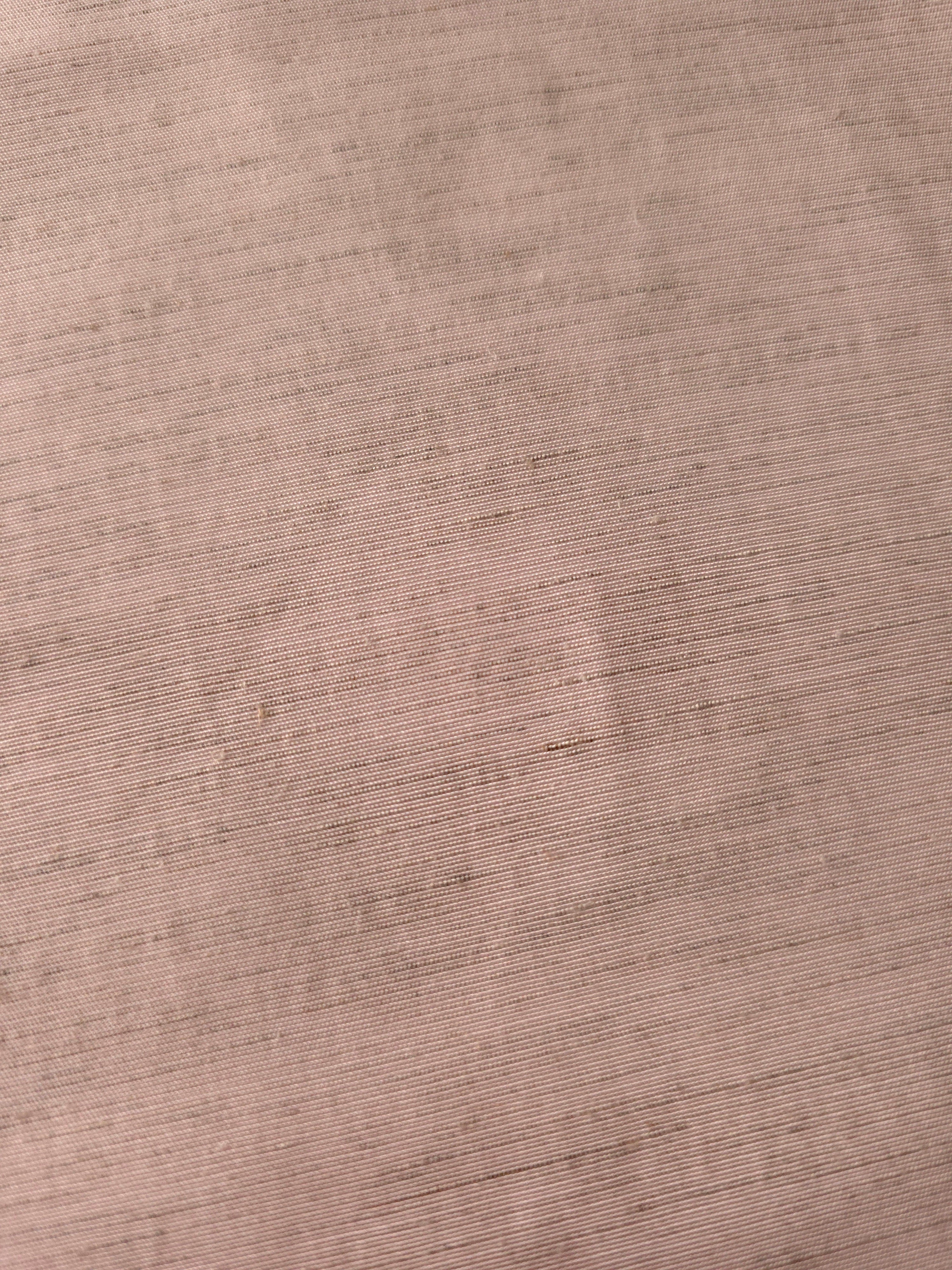 Draped view of soft dusty rose linen viscose plain fabric, showing the fluid drape used for dresses and skirts.
