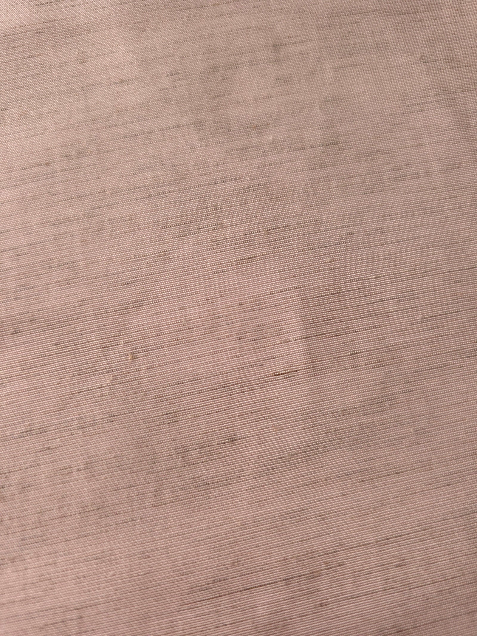 Draped view of soft dusty rose linen viscose plain fabric, showing the fluid drape used for dresses and skirts.