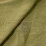 Texture view of fresh apple green linen viscose plain fabric highlighting its flowy, breathable finish.