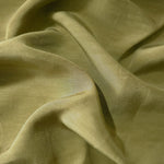 Close-up of fresh apple green linen viscose plain fabric showing its natural woven texture.