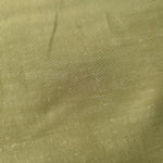 Fresh apple green linen viscose plain fabric draped to show its soft structure, ideal for dressmaking.