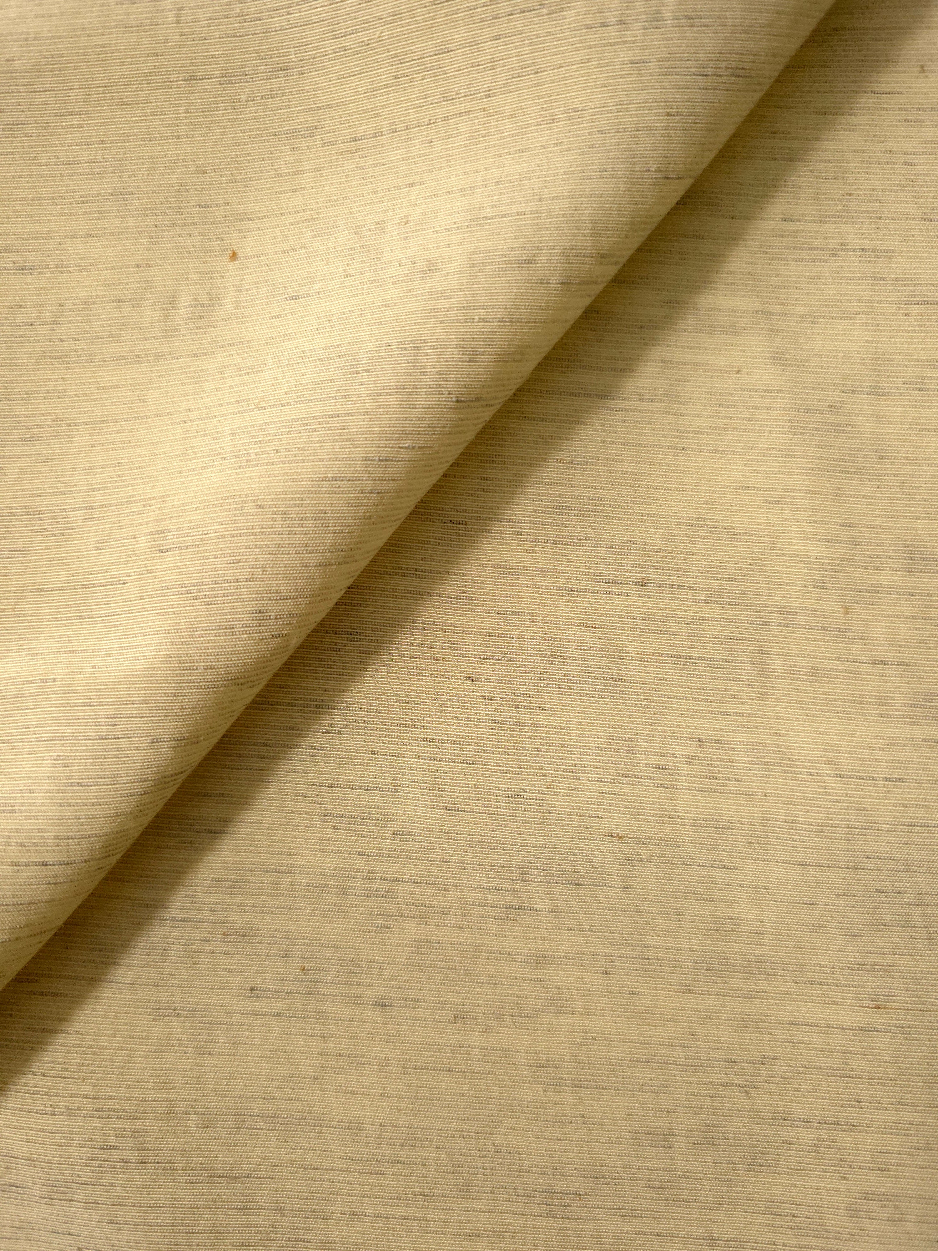 Close-up of soft baby yellow linen viscose plain fabric showing its natural woven texture.