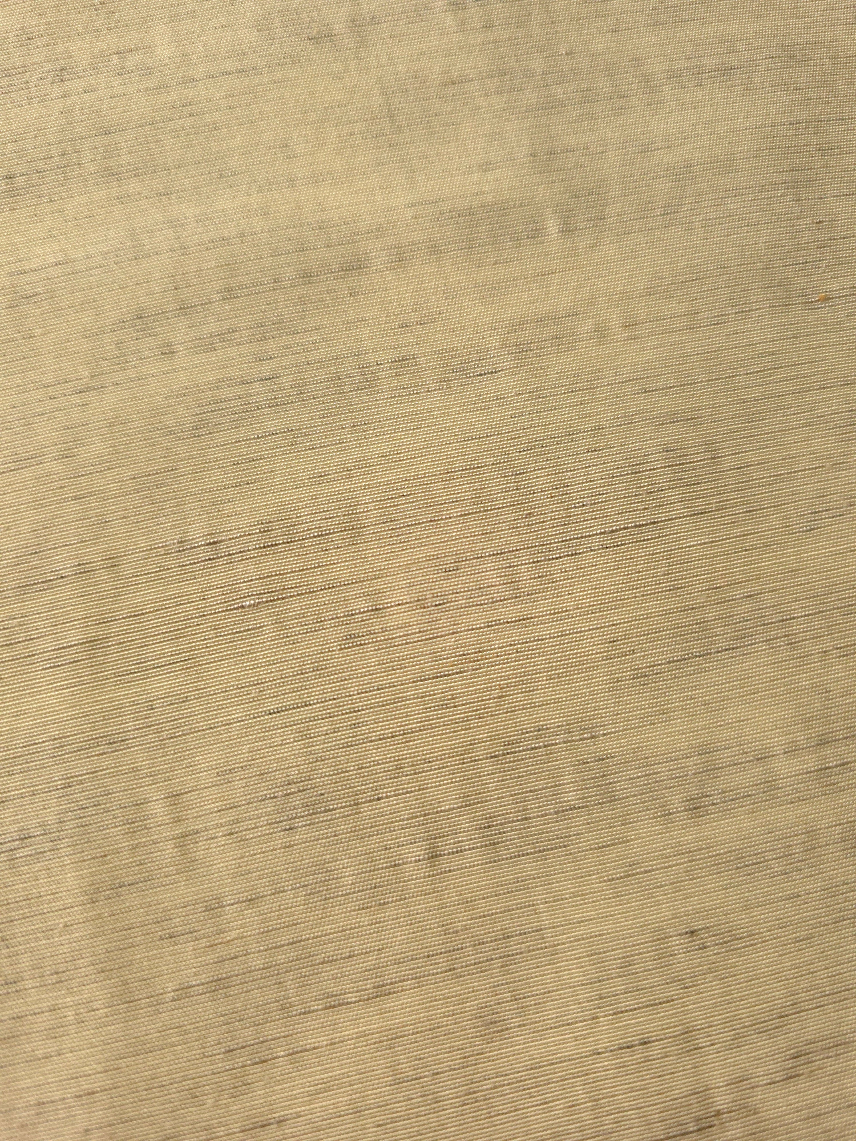 Soft baby yellow linen viscose plain fabric draped to show its soft structure, ideal for dressmaking.